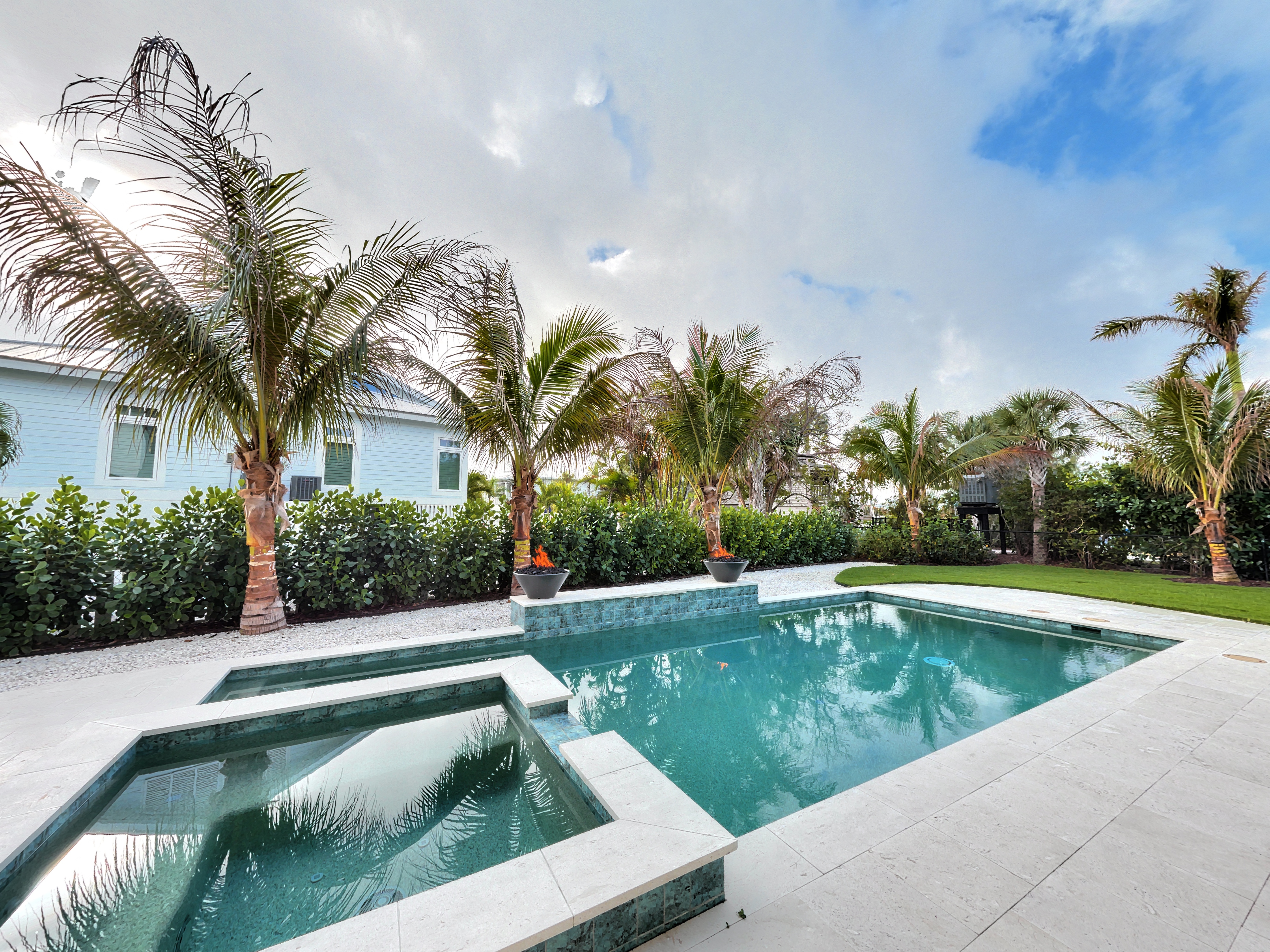Sky replacement before and after for a pool and palm tree listing photo before